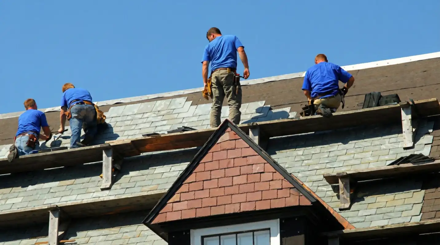 Roof replacement in progress with a team of professional contractors installing new shingles on a residential home in Fort Lauderdale, FL